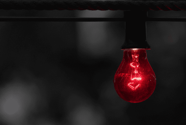 a lightbulb glowing red signifying alert